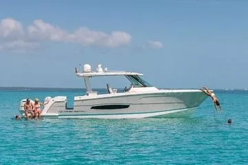 Slide: The Image of 2021 Regal 38 SAV boat on clear blue water with people enjoying a sunny day. - 28