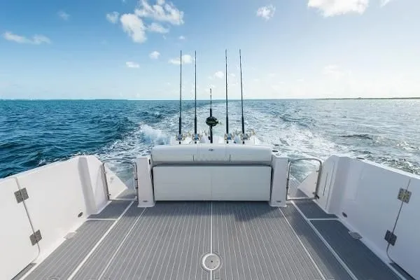 Slide: The Image of 2021 Regal 38 SAV boat cruising on open ocean with fishing rods. - 20