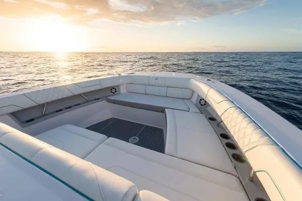 Slide: The Image of Luxurious 2021 Regal 38 SAV boat interior at sunset on open water. - 17