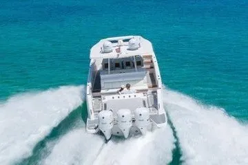 Slide: The Image of 2021 Regal 38 SAV boat cruising on clear blue ocean waters. - 29
