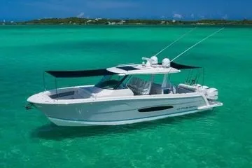 Slide: The Image of 2021 Regal 38 SAV boat on turquoise water, featuring sleek design and sunshades. - 31