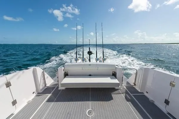 Slide: The Image of 2021 Regal 38 SAV boat cruising on open ocean with fishing rods. - 19