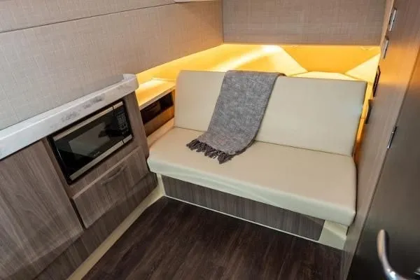 Slide: The Image of 2021 Regal 38 SAV interior with cozy seating, modern cabinetry, and ambient lighting. - 27