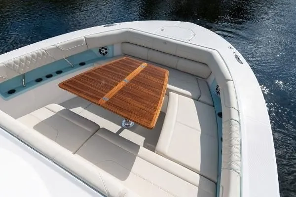 Slide: The Image of Luxurious seating area on 2021 Regal 38 SAV boat with wooden table. - 14