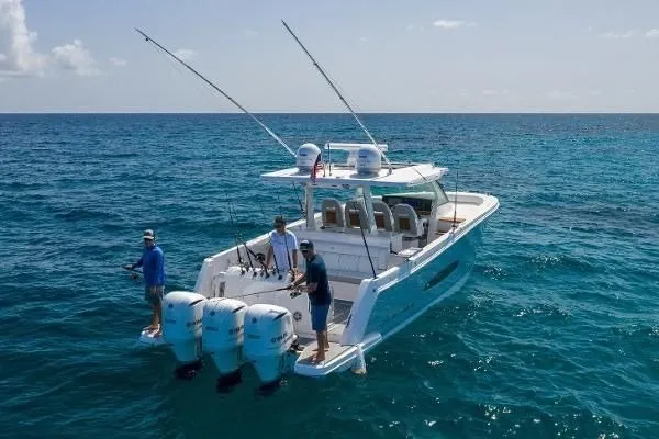 Slide: The Image of 2021 Regal 38 SAV boat with three people fishing in open ocean. - 33