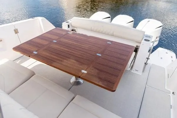 Slide: The Image of 2021 Regal 38 SAV boat with elegant wooden table and cushioned seating. - 15