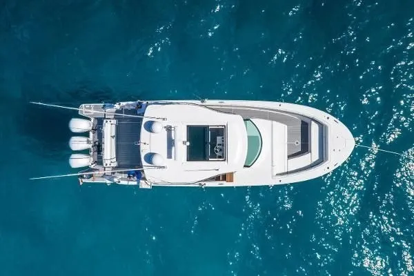 Slide: The Image of Aerial view of 2021 Regal 38 SAV yacht on clear blue water. - 32