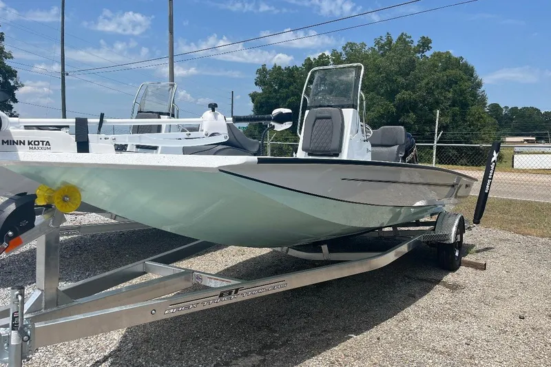 The Image of 2027 Xpress H20 Bay boat on trailer, featuring Minn Kota Maxxum motor. - 1