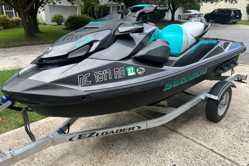 The Image of 2024 Sea-Doo GTR 230 jet ski on trailer, parked in residential driveway. - 4