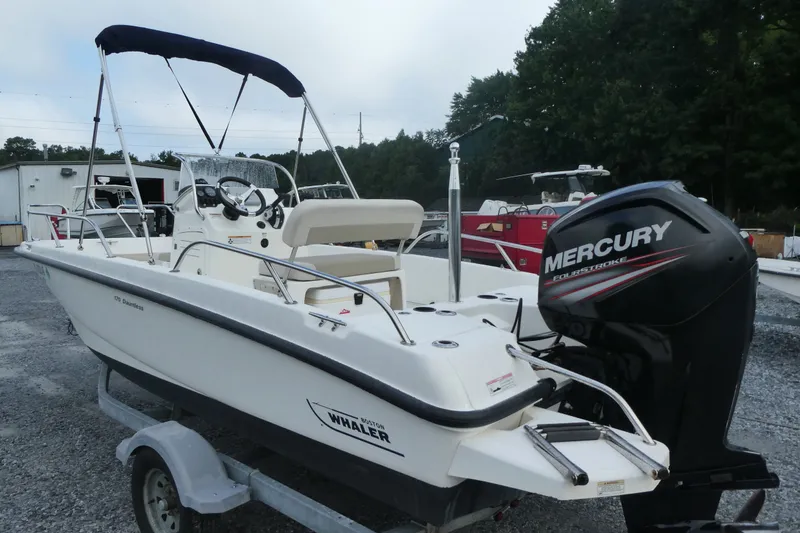 Slide: The Image of 2017 Boston Whaler 170 Dauntless boat with Mercury engine on trailer. - 2