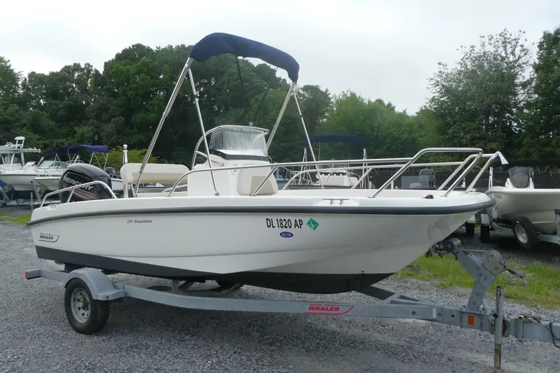 The Image of 2017 Boston Whaler 170 Dauntless boat on trailer, parked outdoors. - 0