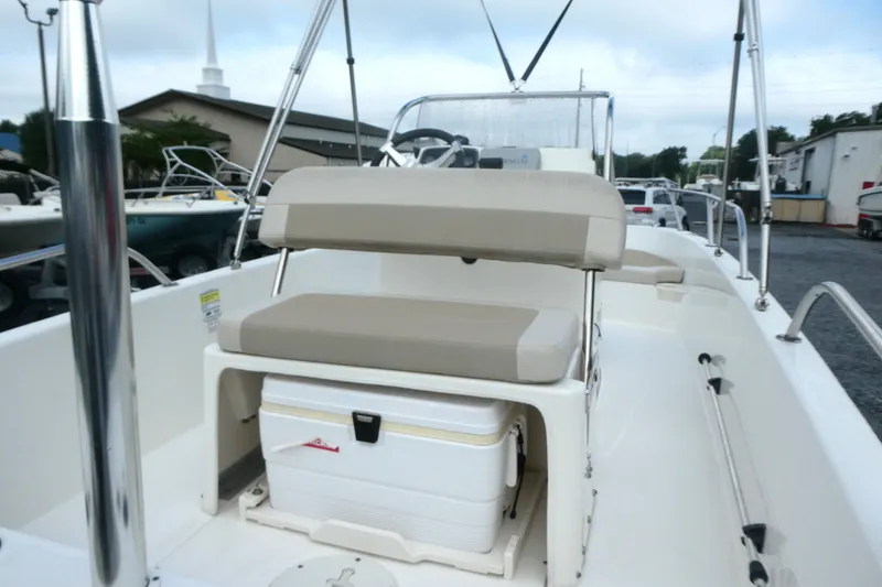 Slide: The Image of 2017 Boston Whaler 170 Dauntless boat interior with seating and storage. - 6