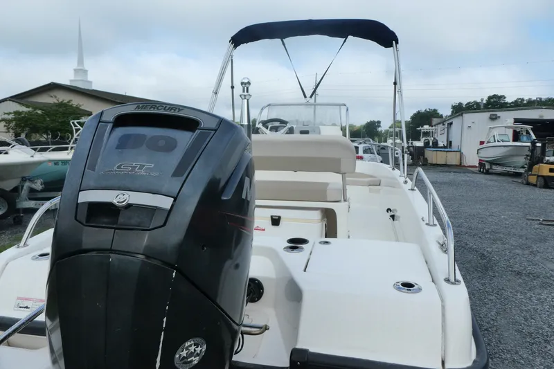 Slide: The Image of 2017 Boston Whaler 170 Dauntless with Mercury outboard motor, parked in a boatyard. - 3