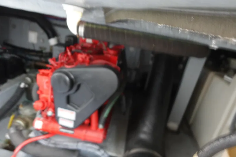Slide: The Image of Engine compartment of a 2001 Sea Ray 410 Express Cruiser, featuring red engine components. - 30