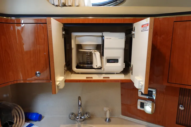 Slide: The Image of Coffee maker in a 2001 Sea Ray 410 Express Cruiser's wooden cabinet. - 18