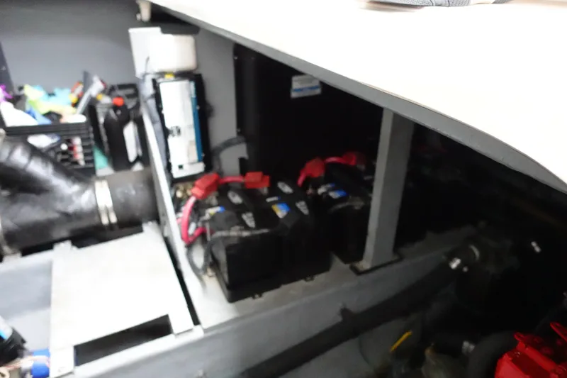 Slide: The Image of Engine compartment of a 2001 Sea Ray 410 Express Cruiser with visible batteries and wiring. - 29