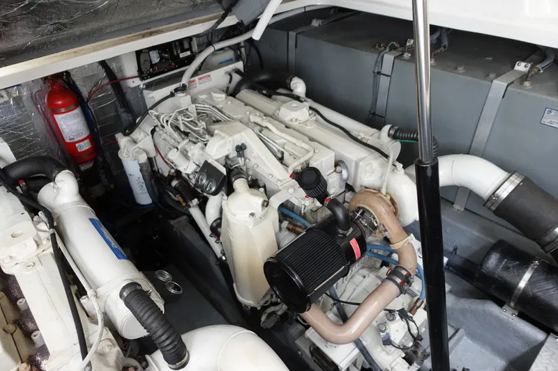 Slide: The Image of Engine room of a 2001 Sea Ray 410 Express Cruiser with visible components and fire extinguisher. - 28