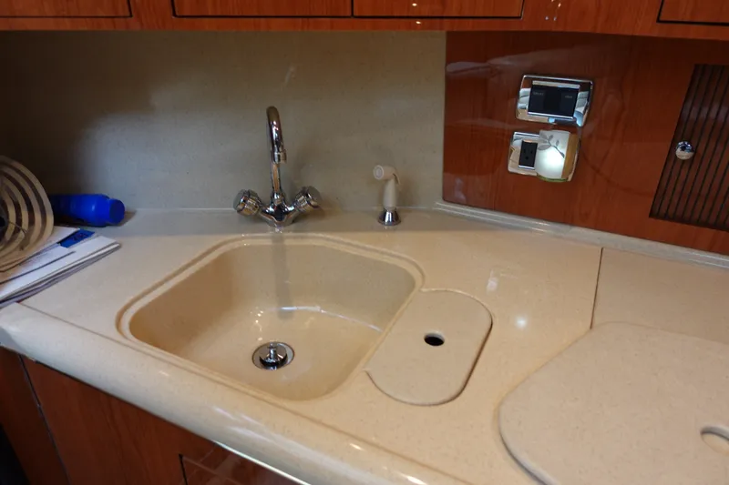 Slide: The Image of Luxurious kitchen sink area in a 2001 Sea Ray 410 Express Cruiser yacht. - 17