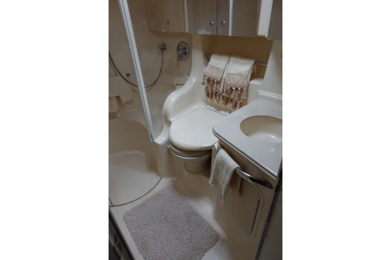Slide: The Image of Bathroom interior of 2001 Sea Ray 410 Express Cruiser with shower and sink. - 24