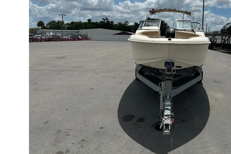 Slide: The Image of 2023 Scout 210 Dorado boat on trailer in parking lot under cloudy sky. - 7