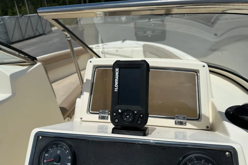 Slide: The Image of 2023 Scout 210 Dorado dashboard with Lowrance navigation system and speedometer. - 14