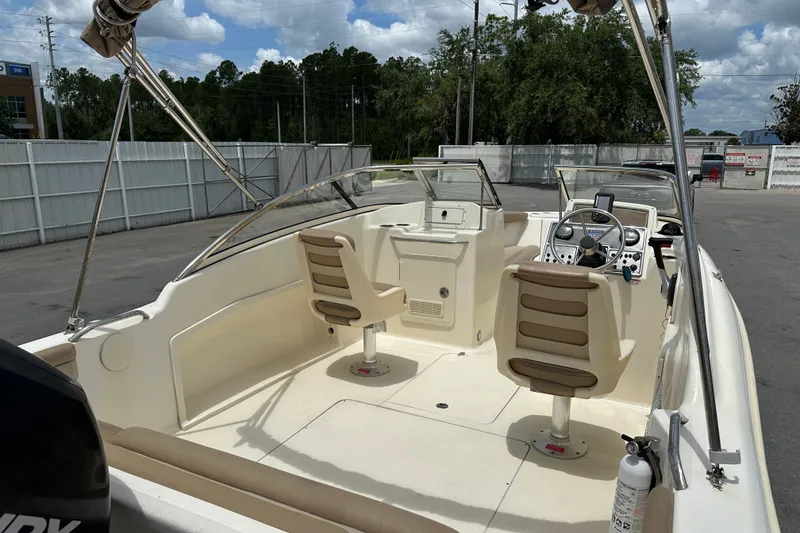 Slide: The Image of 2023 Scout 210 Dorado boat interior with dual seats and steering console. - 9