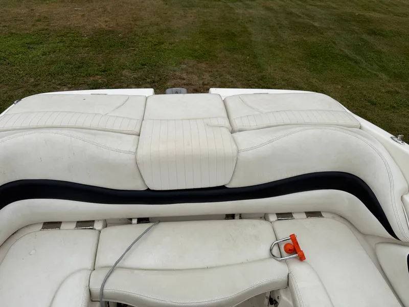 Slide: The Image of The image shows the white upholstery of a 2008 Glastron GX 205, set on grass. - 16