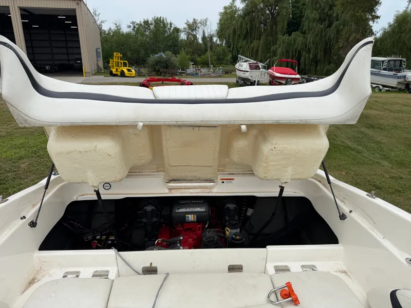 Slide: The Image of The engine compartment of a 2008 Glastron GX 205 is open, revealing the engine and mechanics. - 17