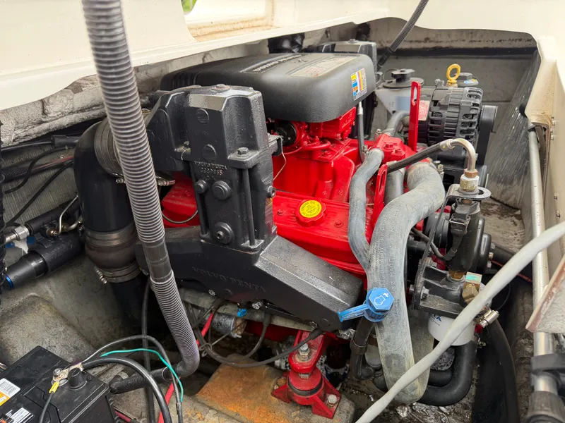 Slide: The Image of Engine compartment of a 2008 Glastron GX 205 with a red engine block and various hoses and wires. - 20