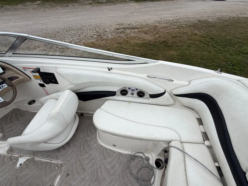 Slide: The Image of The image shows the white interior of a Glastron GX 205 boat with cushioned seating. - 13