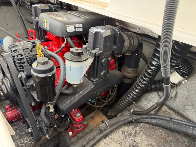 Slide: The Image of Engine compartment of a 2008 Glastron GX 205 with a red engine and black components. - 19
