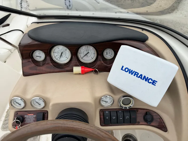 Slide: The Image of Dashboard of a 2008 Glastron GX 205 with gauges and a Lowrance device. - 14