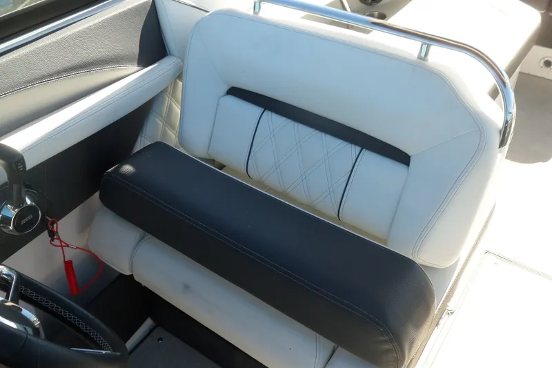 Slide: The Image of 2020 Regal LS6 boat interior with white and black seating, featuring modern design and stitching. - 24