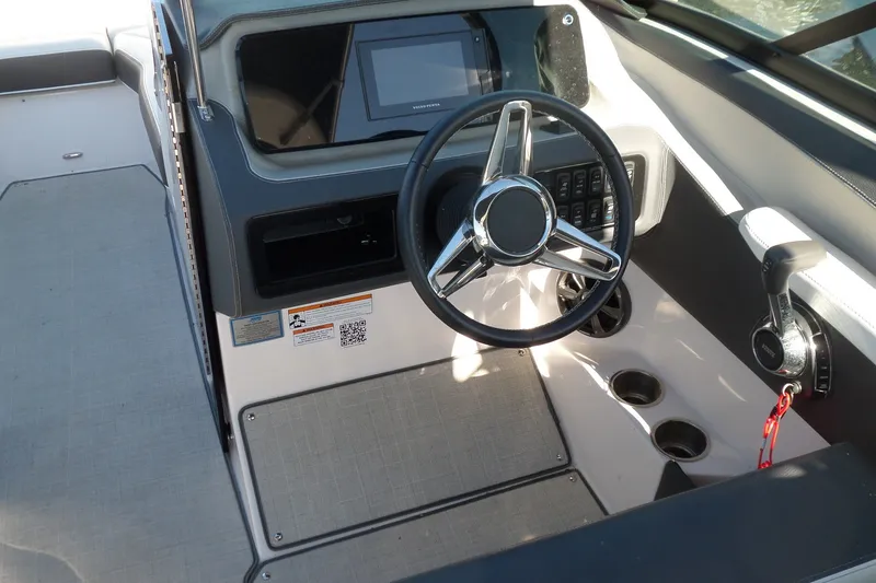 Slide: The Image of 2020 Regal LS6 boat cockpit with steering wheel and control panel. - 14