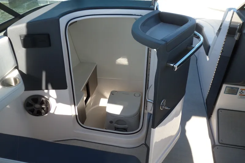 Slide: The Image of 2020 Regal LS6 boat interior with compact marine toilet and storage area. - 20