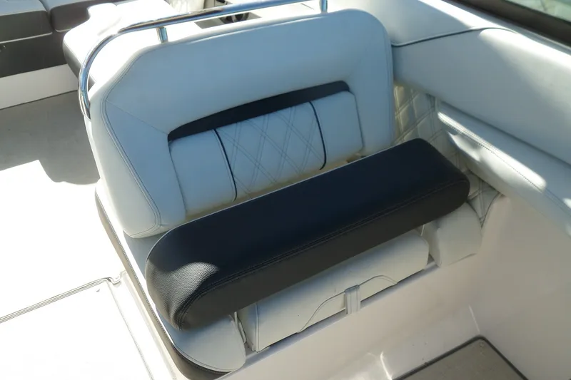 Slide: The Image of 2020 Regal LS6 boat seat with white and black upholstery, featuring diamond stitching. - 21