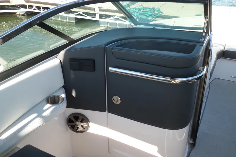Slide: The Image of 2020 Regal LS6 boat interior with cup holder and speaker, dockside view. - 13