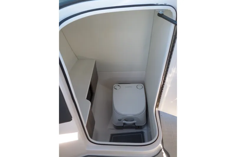 Slide: The Image of Compact bathroom in 2020 Regal LS6 boat, featuring a portable toilet. - 18