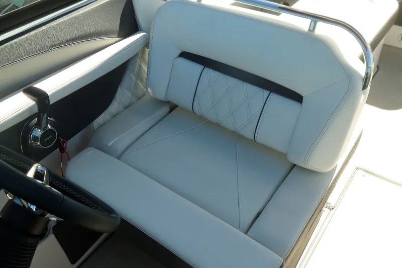 Slide: The Image of 2020 Regal LS6 boat interior with luxurious white seating and steering wheel. - 25