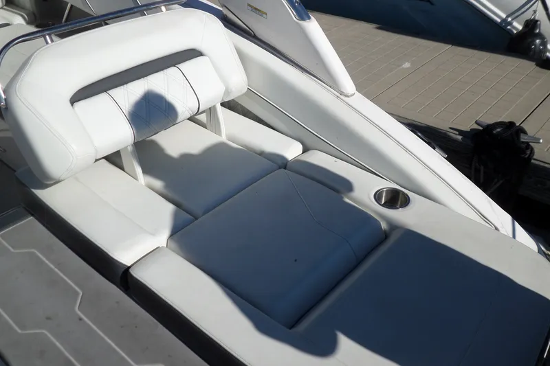 Slide: The Image of Luxurious white seating on a 2020 Regal LS6 boat, featuring a cup holder. - 34