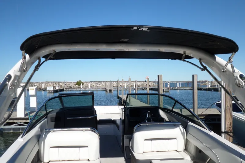 Slide: The Image of 2020 Regal LS6 boat docked at marina with clear blue sky. - 36