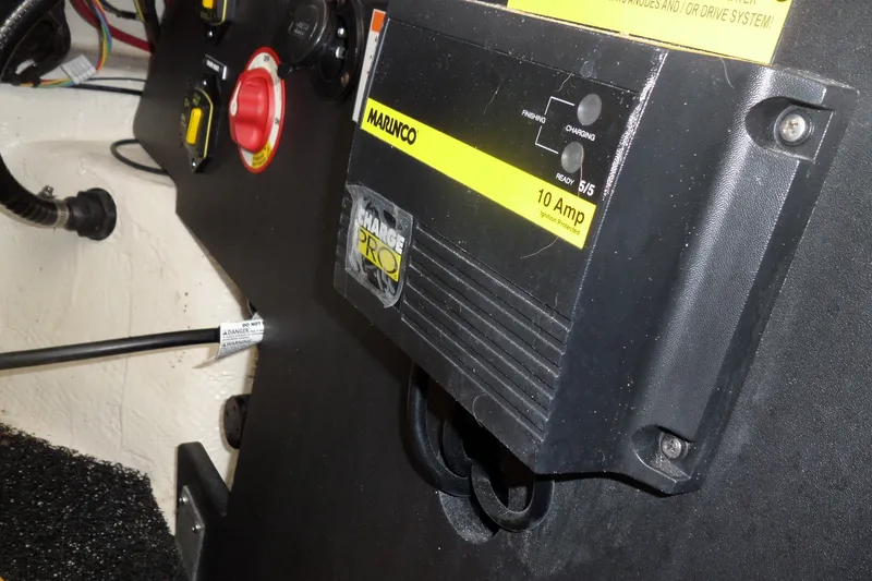 Slide: The Image of Battery charger setup in a 2020 Regal LS6 boat, featuring a Marinco Charge Pro 10 Amp unit. - 32