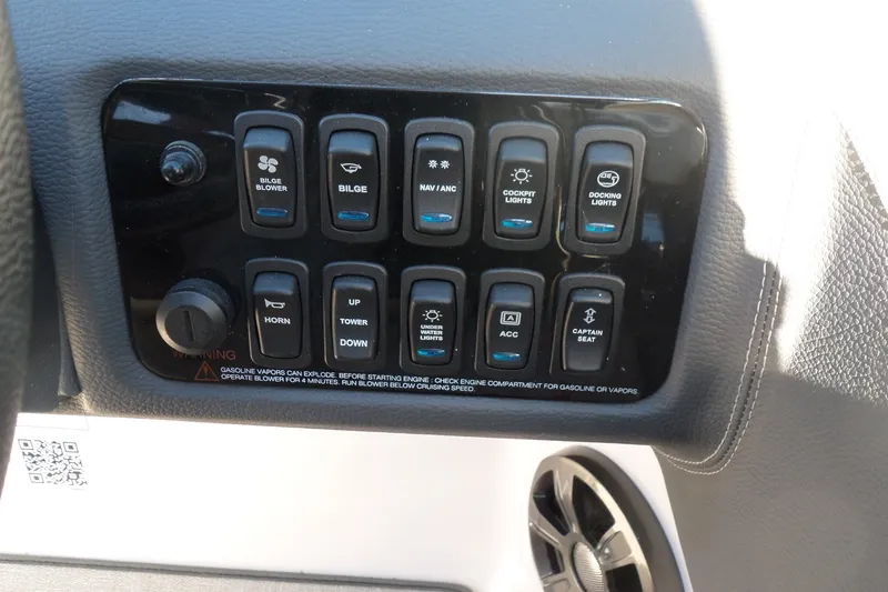 Slide: The Image of Control panel of a 2020 Regal LS6 boat with various switches and buttons. - 27