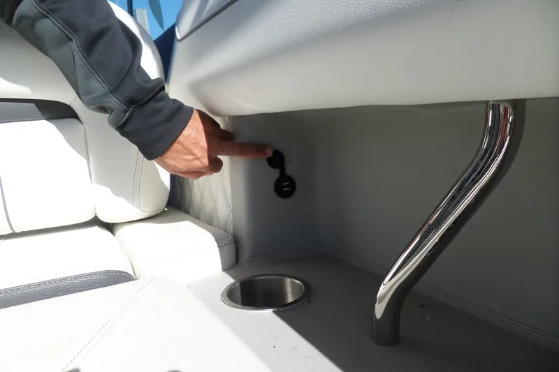Slide: The Image of Person interacting with a control panel inside a 2020 Regal LS6 boat. - 37