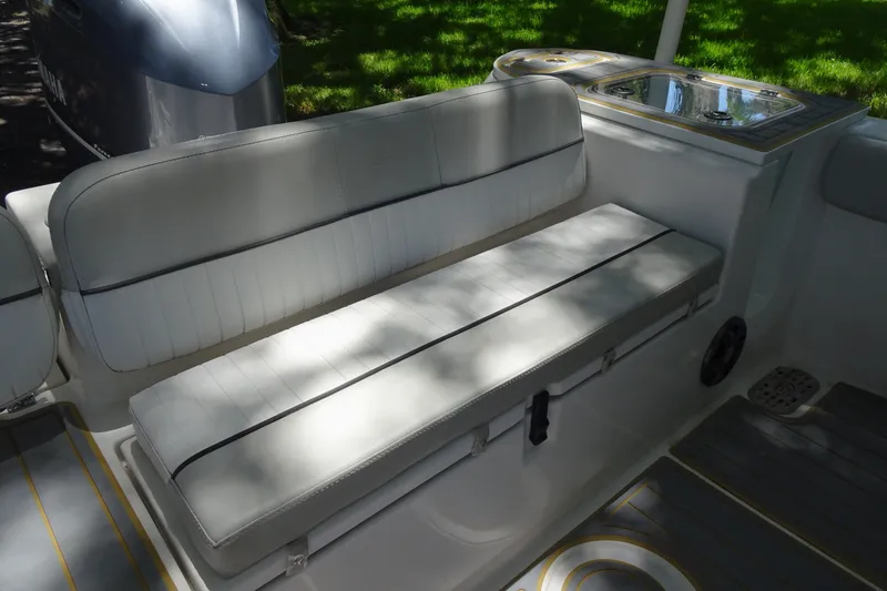 Slide: The Image of 2021 Sea Fox 248 Commander boat interior with cushioned seating and storage. - 11