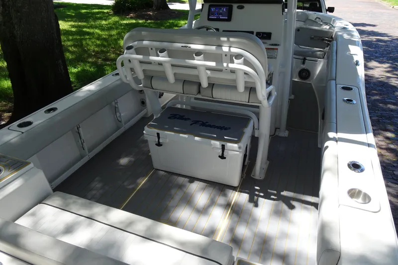 Slide: The Image of 2021 Sea Fox 248 Commander boat interior with seating and cooler on deck. - 8
