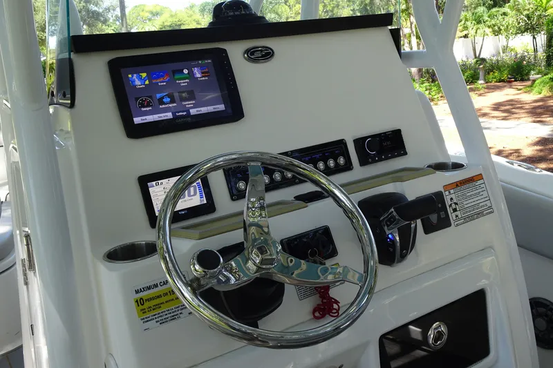 Slide: The Image of Dashboard of a 2021 Sea Fox 248 Commander boat with steering wheel and navigation controls. - 14
