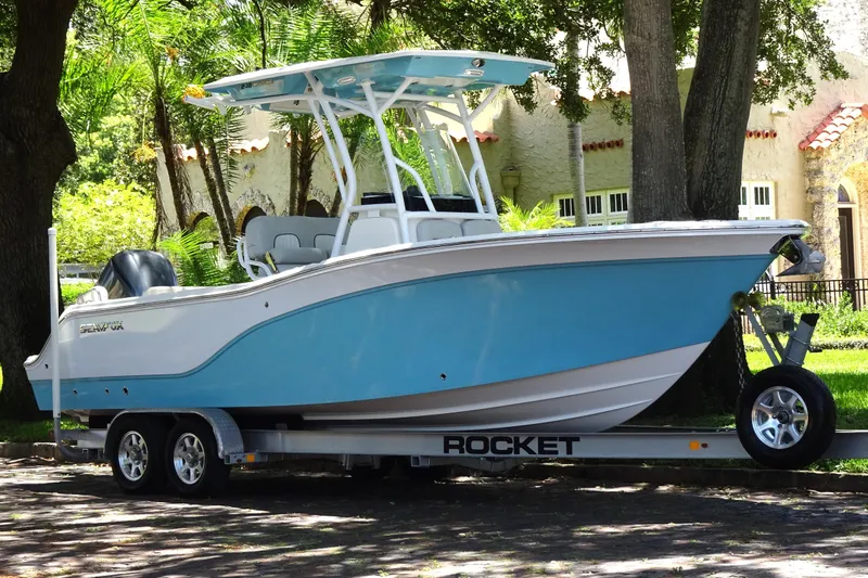 Slide: The Image of 2021 Sea Fox 248 Commander boat on trailer, parked under trees. - 5