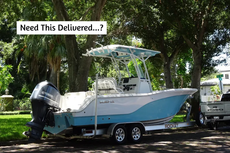 Slide: The Image of 2021 Sea Fox 248 Commander boat on trailer, parked under trees. - 2