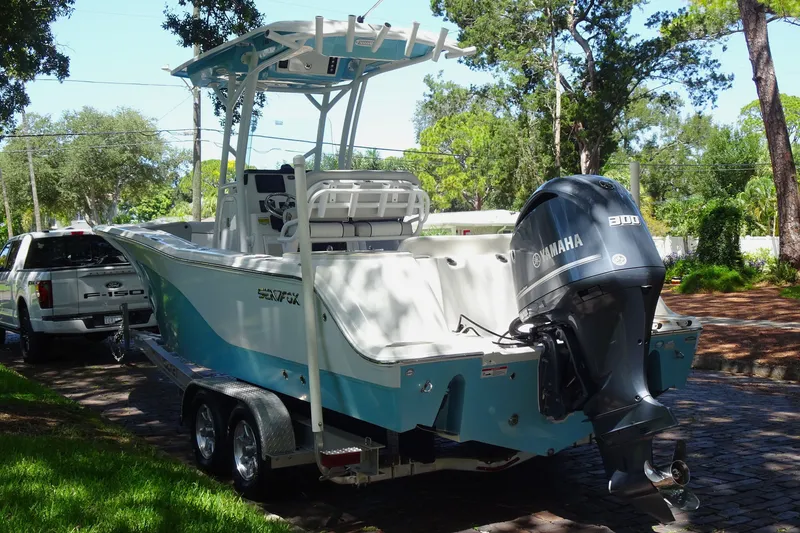 Slide: The Image of 2021 Sea Fox 248 Commander boat with Yamaha engine on trailer, parked outdoors. - 4